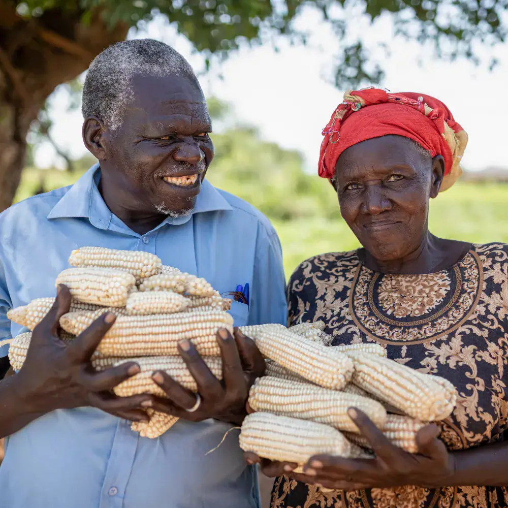 A group of three men, and three African women are going to somewhere, and they are smiling towards the camera