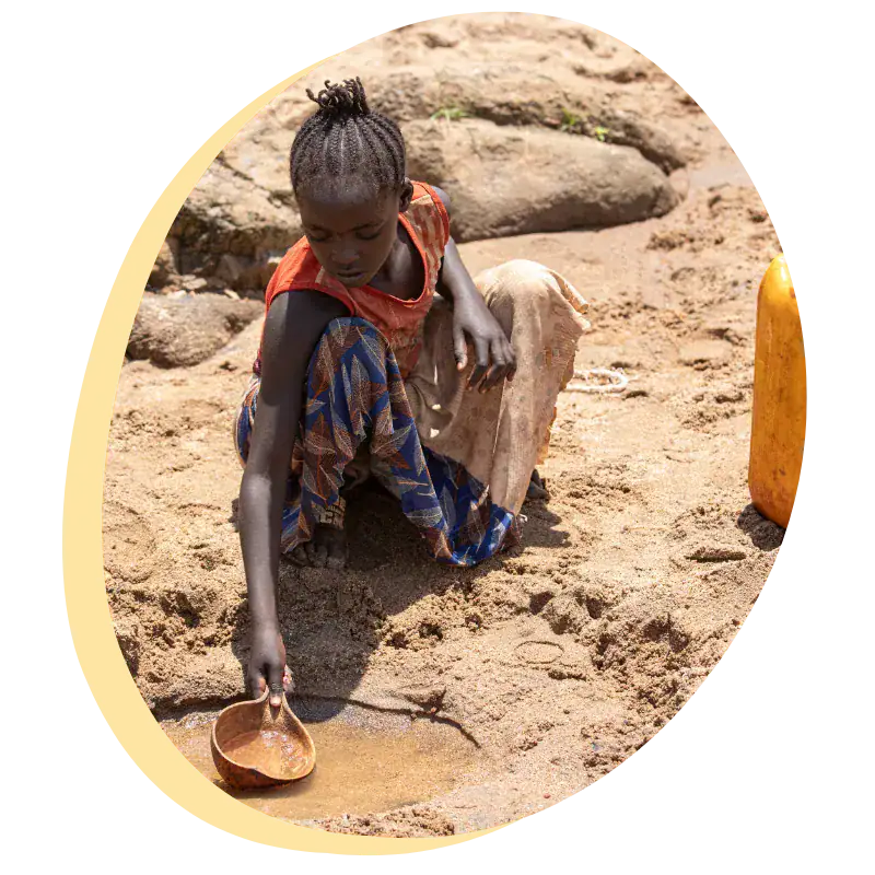 the crisis - dirty water Ethiopian village girl scooping up dirty water from a mud hole to bring back to her family.