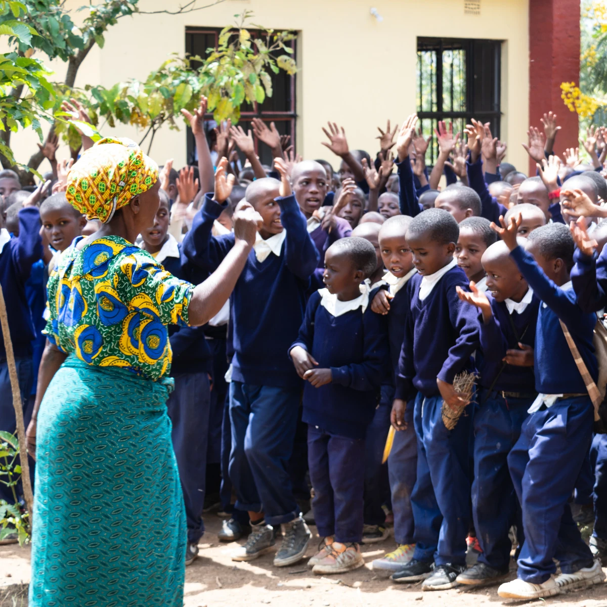 Two African women smiling by holding hands on each other's shoulders