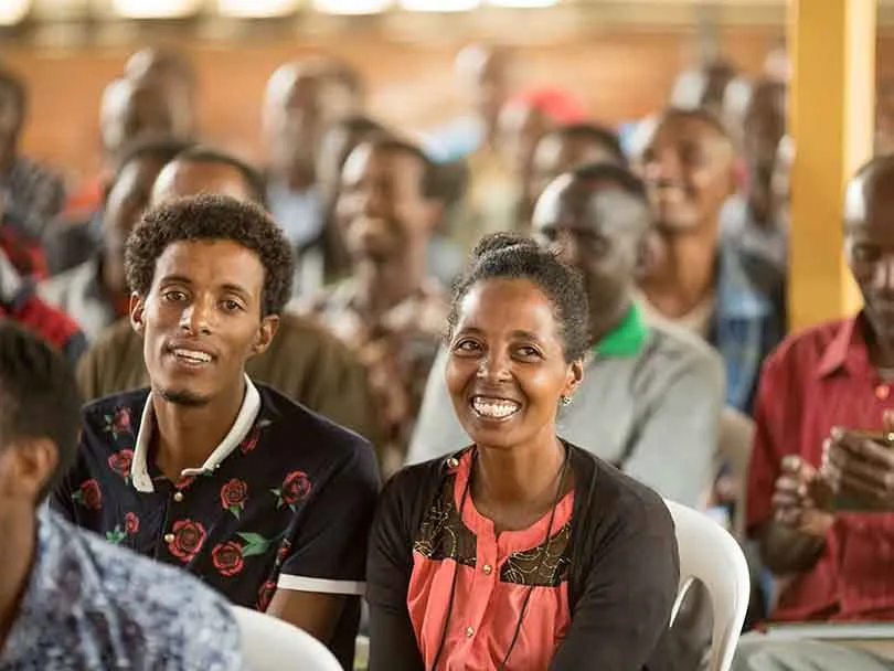 African couple smiling while looking at camera