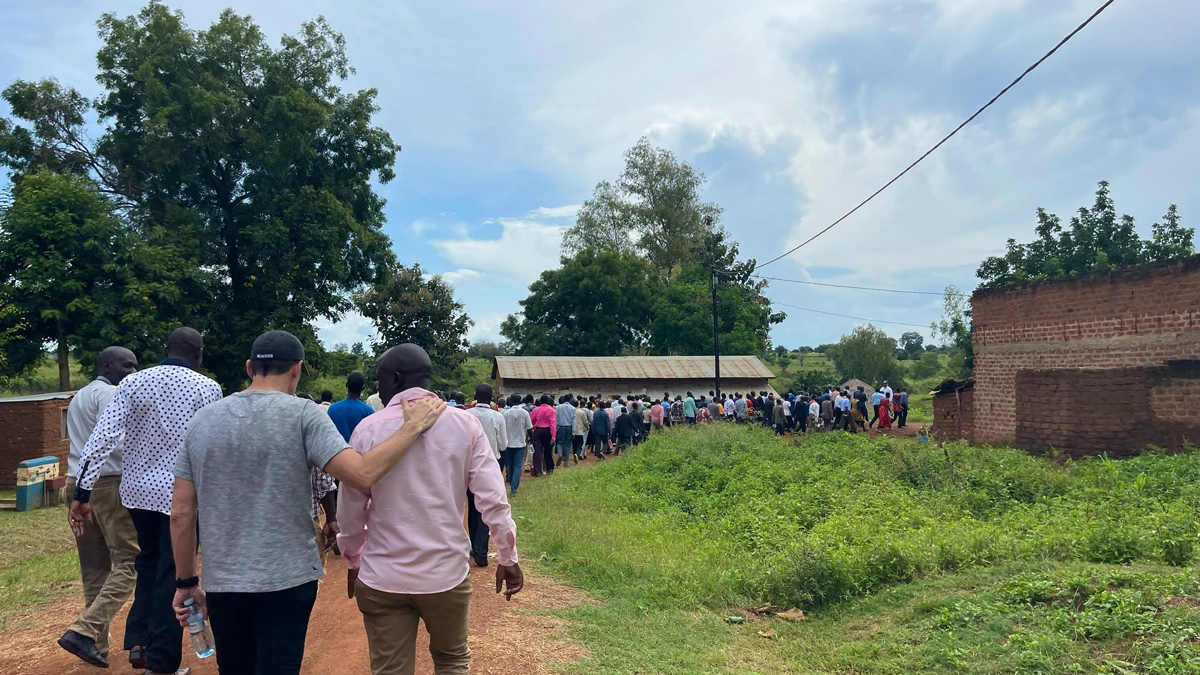Crowd of people walking down the road towards the training locaction