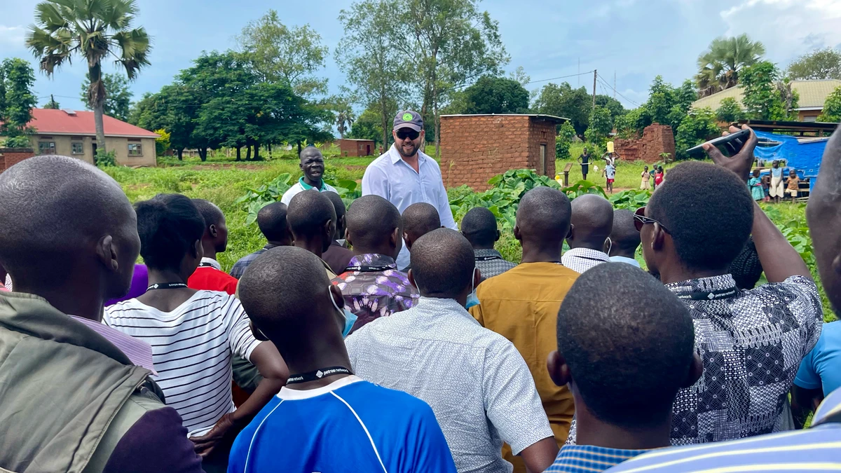 Man in sunglasses talking to a crowd