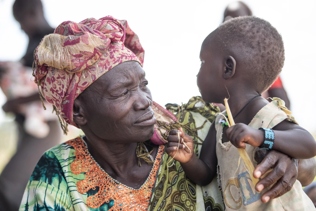 South Sudanese woman and her baby looking at each other.