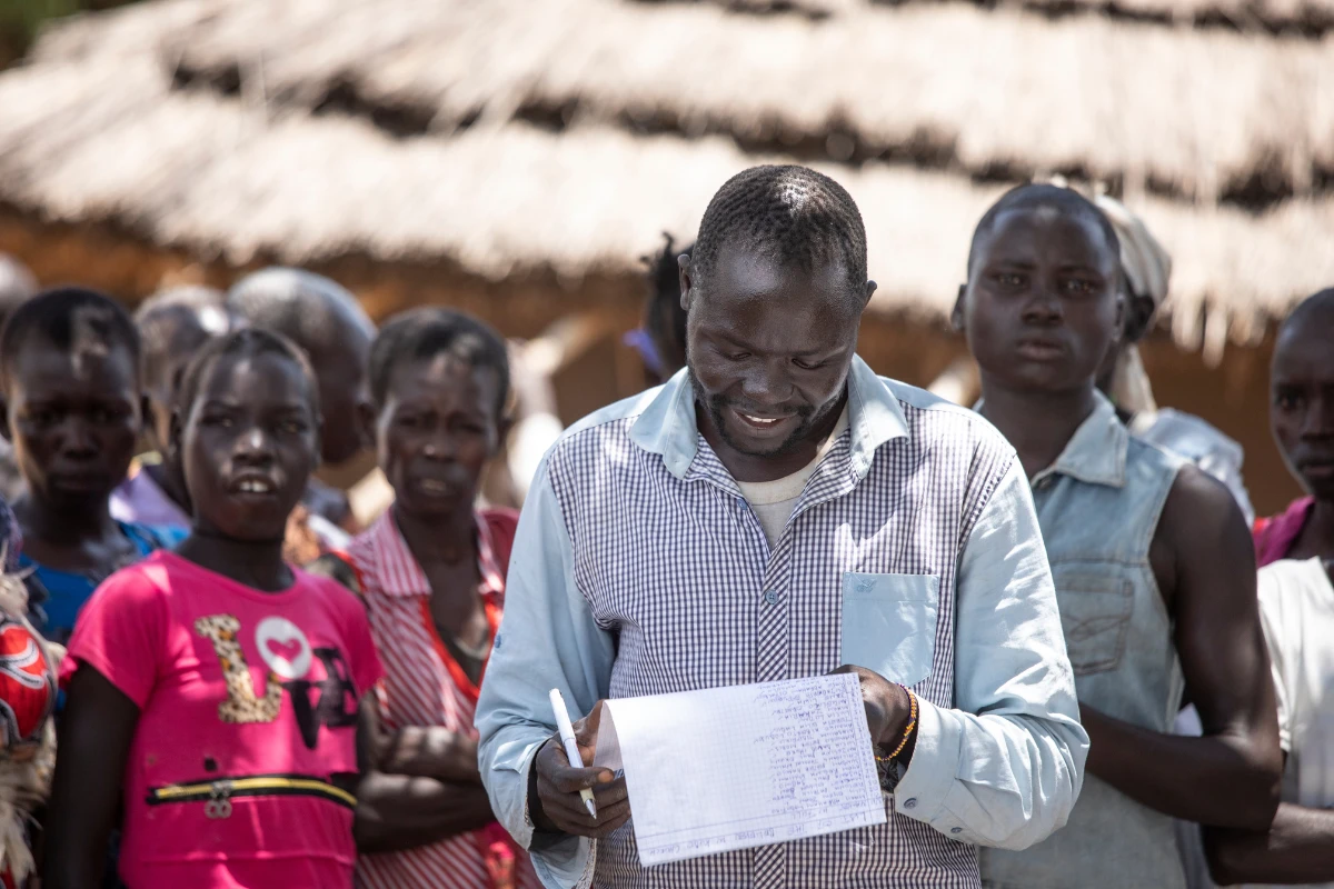 Petros Network indigenous missionary leading a group of church members through a food distribution where they received emergency supplies to feed their family.