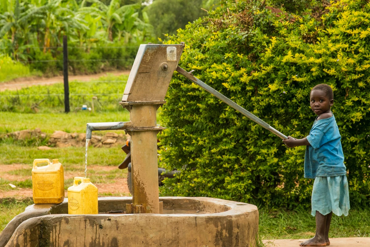 Child drawing water from a well