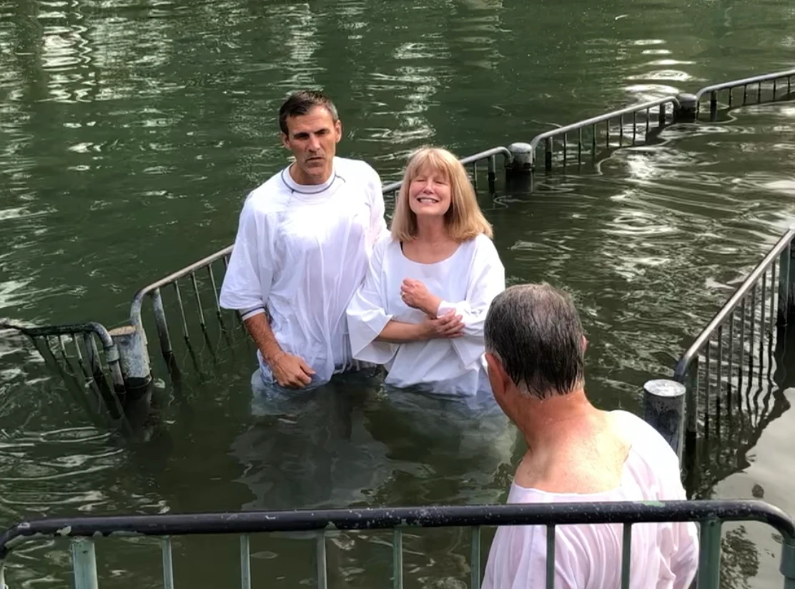 Sandy Cooper standing in a river before her baftism