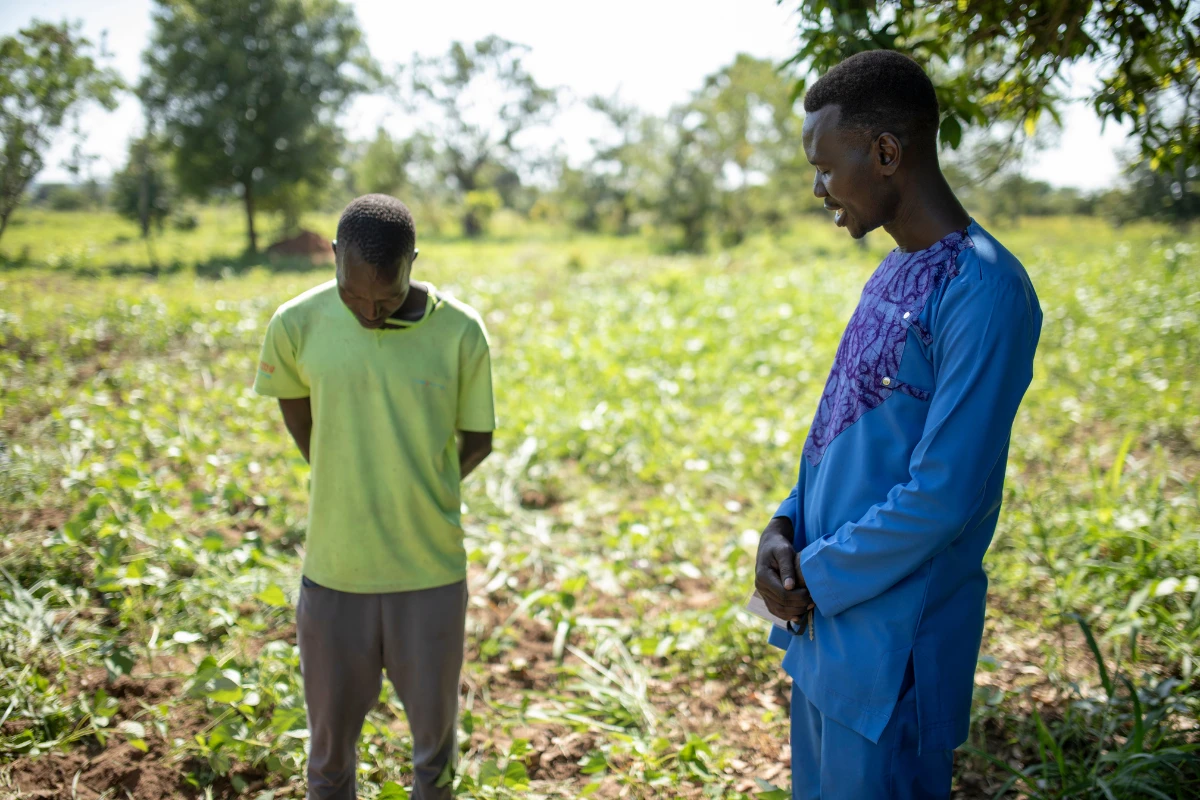 Two men standing by garden