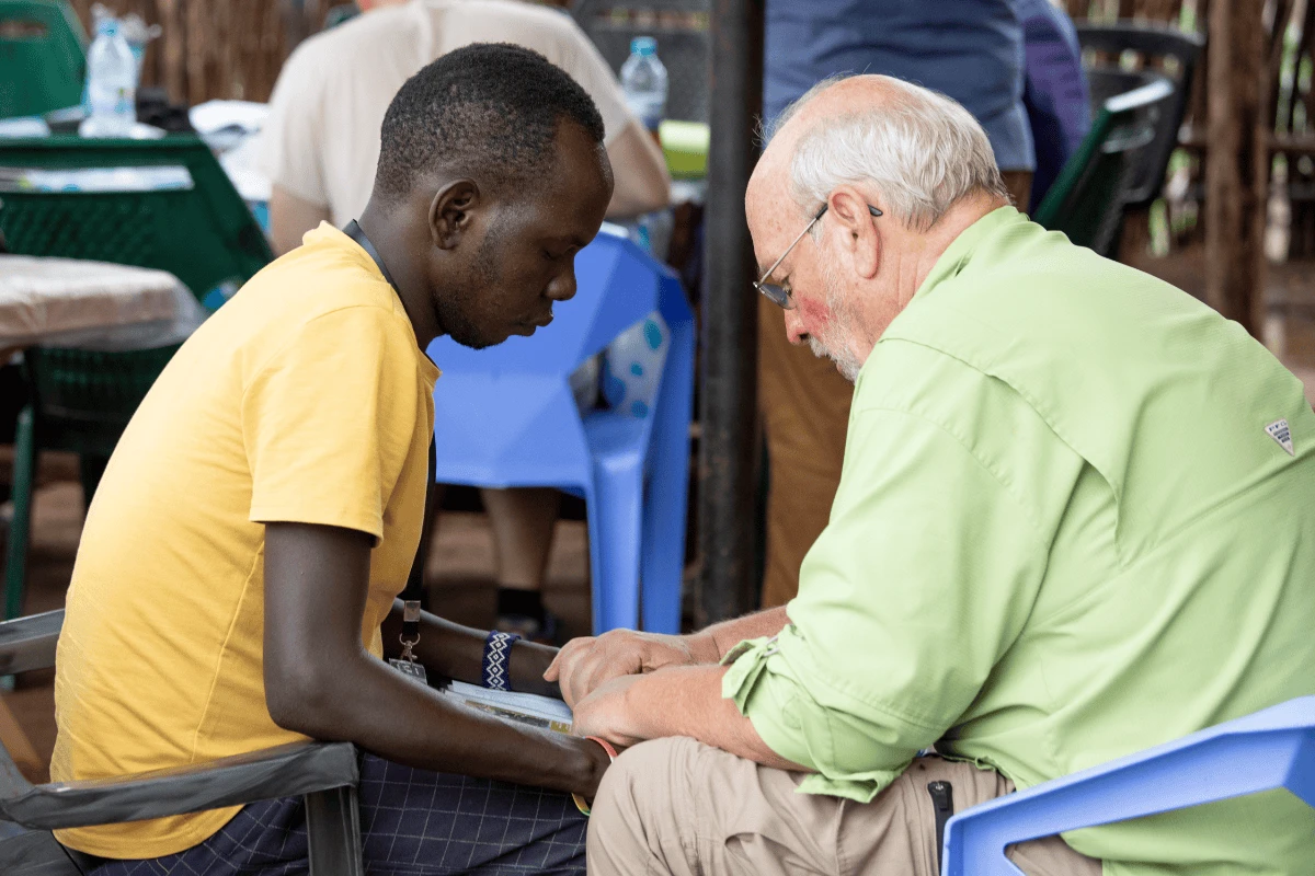 David Martin praying with a Petros Network church planter